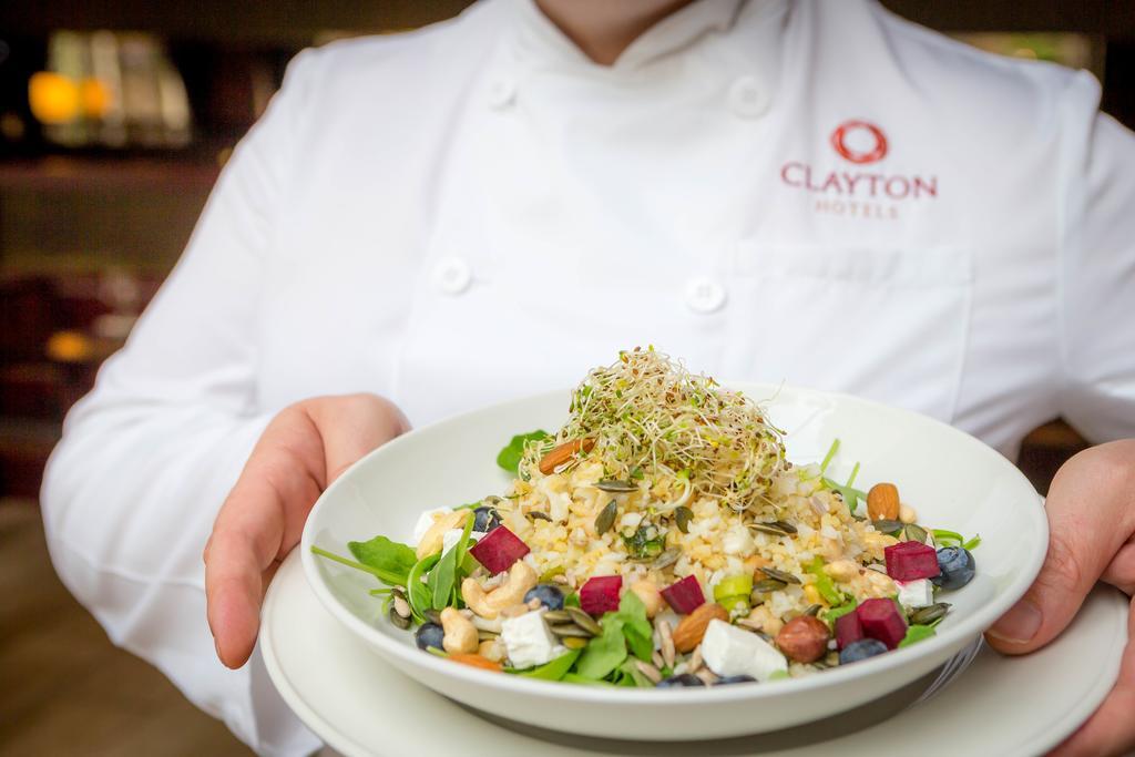Clayton Hotel Dublin Airport Coolock Esterno foto Chef holding a plate of food