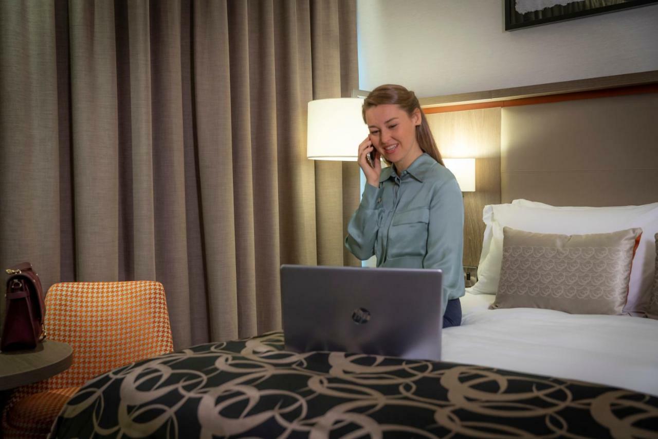 Clayton Hotel Dublin Airport Coolock Esterno foto A woman working from home.